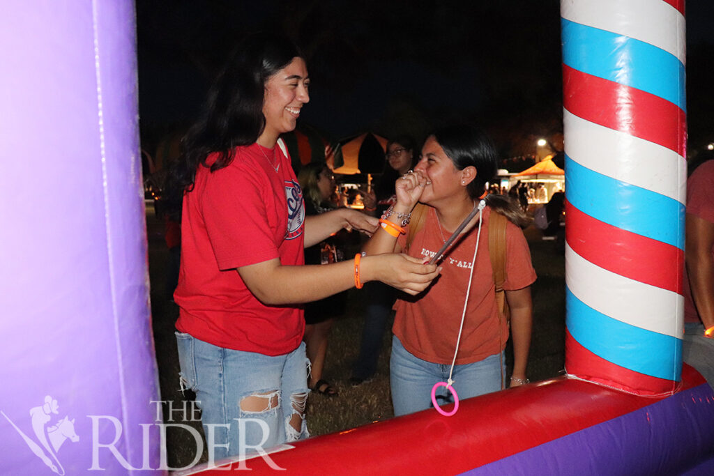 Exercise science juniors Karen Vega and Andrea Sanchez play the “Grand Carnival Fishing” game Aug. 27 at The Stomp on the Student Union lawn on the Brownsville campus. The event featured laser tag, a video game station, carnival games, food and arts and crafts stations. About 800 students attended the event, officials said. Silvana Villarreal/THE RIDER